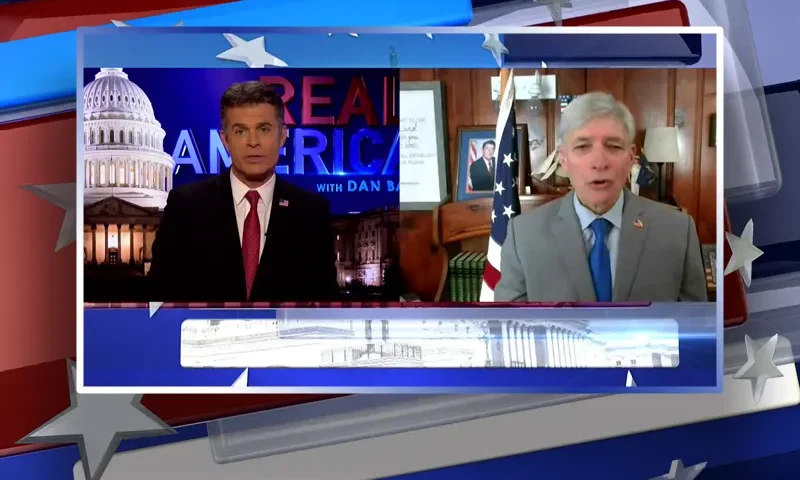 Video still from Real America on One America News Network showing a split screen of the host on the left side, and on the right side is the guest, Lt. Steve Rogers.
