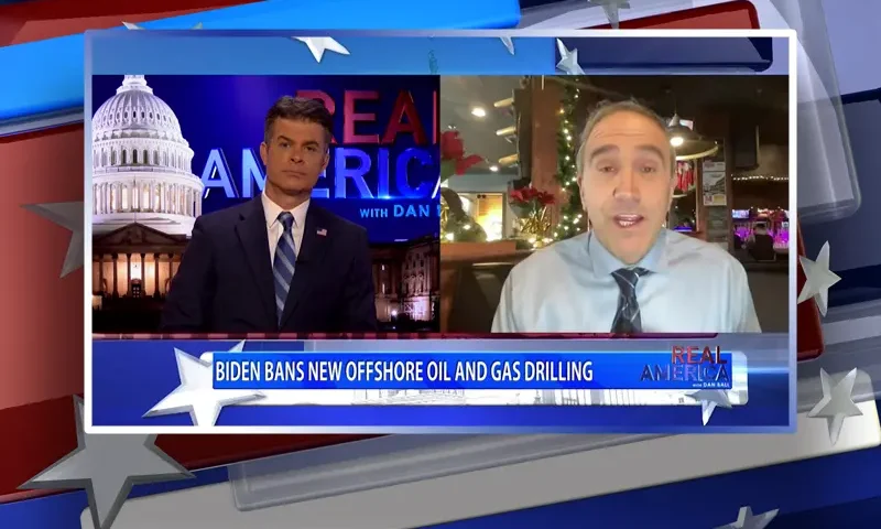 Video still from Real America on One America News Network showing a split screen of the host on the left side, and on the right side is the guest, Marc Morano.