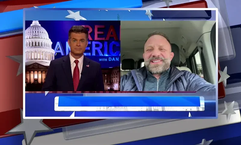 Video still from Real America on One America News Network showing a split screen of the host on the left side, and on the right side is the guest, Chad Robichaux.