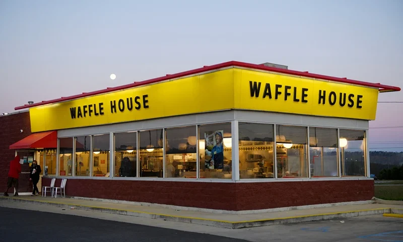 Customers exit a Waffle House restaurant as the moon sets on March 29, 2021 in Bessemer, Alabama. - Votes are set to be counted on March 29, 2021 on whether to create the first Amazon union in the United States, at a warehouse in Alabama, after a historic, five months-long David vs Goliath campaign. "I'm proud of the workers at Amazon for standing up and saying enough," said Joshua Brewer, the local president of the Retail, Wholesale and Department Store Union. (Photo by Patrick T. FALLON / AFP) (Photo by PATRICK T. FALLON/AFP via Getty Images)