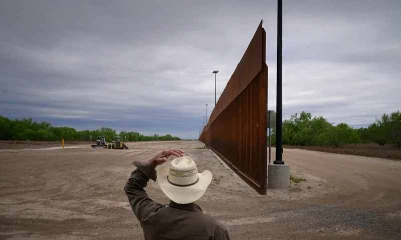 TOPSHOT - In a photo taken on March 28, 2021 ranch owner Tony Sandoval (67) stands before a portion of the unfinished border wall that former US president Donald Trump tried to build, near the southern Texas border city of Roma. - The 11,000 inhabitants of the Texas border town Roma have been living with illegal immigrants for decades. Many have mixed feelings about the new arrivals: empathy and compassion on the one hand - especially since many of their family members also arrived in the United States illegally - but also concern and fear about the growing number of migrants in recent months. Sometimes 500 per night, many of them families or unaccompanied minors. (Photo by Ed JONES / AFP) (Photo by ED JONES/AFP via Getty Images)
