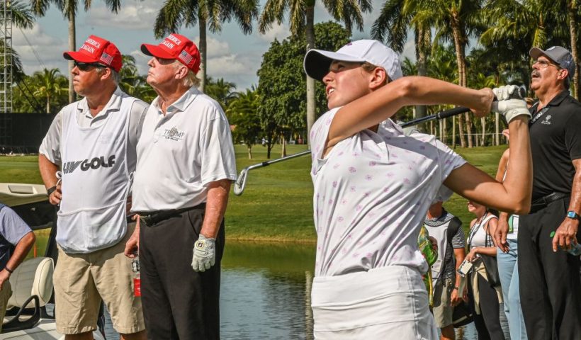 Former US President Donald Trump (2nd L) watches his granddaughter, Kai Trump, play golf at Trump National Doral Miami golf club on October 27, 2022 in Miami, Florida, a day ahead of the 2022 LIV Golf Invitational Miami. (Photo by Giorgio VIERA / AFP) (Photo by GIORGIO VIERA/AFP via Getty Images)