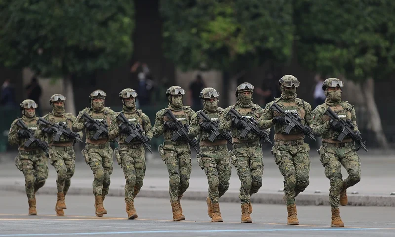 VARIOUS CITIES, MEXICO - SEPTEMBER 16: Marines march during the Independence Day military parade at Zocalo Square on September 16, 2020 in Various Cities, Mexico. This year El Zocalo remains closed for general public due to coronavirus restrictions. Every September 16 Mexico celebrates the beginning of the revolution uprising of 1810. (Photo by Hector Vivas/Getty Images)