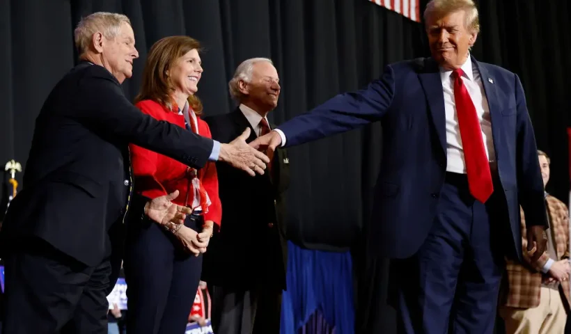 MANCHESTER, NEW HAMPSHIRE - JANUARY 20: Republican presidential candidate and former President Donald Trump (R) shakes hands with Rep. Joe Wilson (R-SC) as a group of South Carolina politicians join Trump on stage during a campaign rally at the SNHU Arena on January 20, 2024 in Manchester, New Hampshire. Trump is rallying four days before New Hampshire. (Photo by Chip Somodevilla/Getty Images)