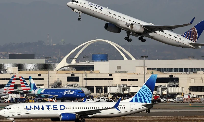 A United Airlines plane takes off as another taxis at Los Angeles International Airport (LAX) following the Thanksgiving holiday on December 2, 2024 in Los Angeles, California. According to the Transportation Security Administration (TSA), Thanksgiving Sunday was the busiest day for commercial airline travel ever, with preliminary numbers indicating more than 3 million travelers were screened in U.S. airports yesterday with many people still making their way home today. (Photo by Mario Tama/Getty Images)