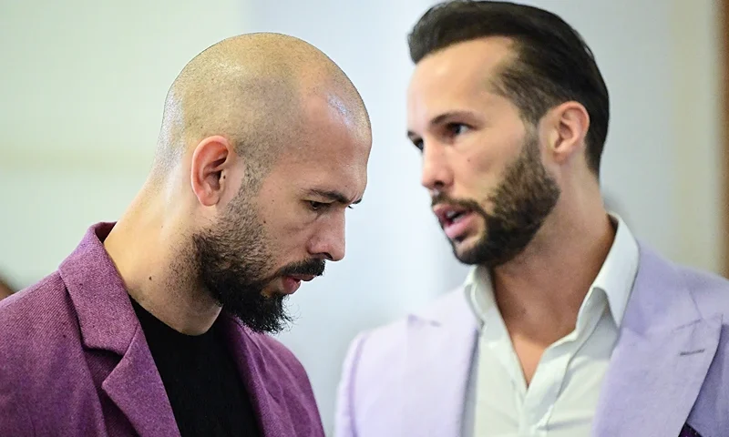 Andrew Tate (L) and his brother Tristan Tate are pictured inside The Court of Appeal in Bucharest, Romania, on December 10, 2024. The US-born Briton, Andrew, and his brother Tristan, who say they are innocent, are accused of having formed an organised criminal network in early 2021 in Romania and in Britain. Prosecutors allege that the brothers and two women set up a criminal organisation and sexually exploited several victims. (Photo by Daniel MIHAILESCU / AFP) (Photo by DANIEL MIHAILESCU/AFP via Getty Images)