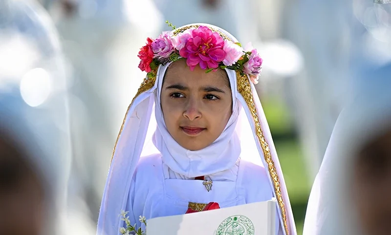 Iraqi Muslim girls, who traditionally begin wearing the hijaba head covering worn in publicat the mandatory age of nine, take part in a ceremony organized at a stadium in Basra on December 19, 2024. (Photo by Hussein FALEH / AFP) (Photo by HUSSEIN FALEH/AFP via Getty Images)