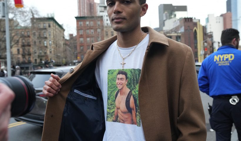 A Luigi Mangione supporter wears a shirt with his picture outside Manhattan Federal Court in lower Manhattan as Luigi Mangione, the suspect in the United Healthcare CEO killing has waived extradition to New York on December 19, 2024. Mangione, 26, is accused of shooting UnitedHealthcare chief executive Brian Thompson on a Manhattan street on December 4, triggering a nationwide manhunt that ended last week when he was spotted at a Pennsylvania McDonald's. The former data engineer remains jailed in that state as he fights efforts to extradite him to New York to face charges there over the killing. (Photo by Bryan R. SMITH / AFP) (Photo by BRYAN R. SMITH/AFP via Getty Images)