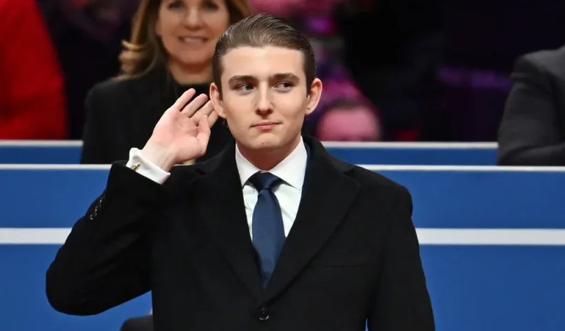 Barron Trump gestures after being acknowledged by his father US President Donald Trump during the inaugural parade inside Capital One Arena, in Washington, DC, on January 20, 2025. (Photo by ANGELA WEISS / AFP) (Photo by ANGELA WEISS/AFP via Getty Images)