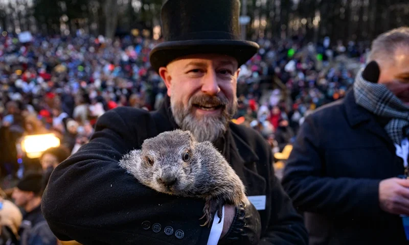 : Groundhog handler AJ Dereume holds Punxsutawney Phil after he saw his shadow predicting 6 more weeks of winter during the 139th annual Groundhog Day festivities on Friday February 2, 2025 in Punxsutawney, Pennsylvania. Groundhog Day is a popular tradition in the United States and Canada. If Punxsutawney Phil sees his shadow he regards it as an omen of six more weeks of bad weather and returns to his den. Early spring arrives if he does not see his shadow, causing Phil to remain above ground. (Photo by Jeff Swensen/Getty Images)
