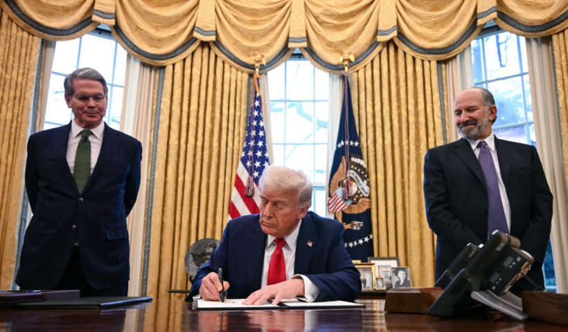 US President Donald Trump, alongside Secretary of Treasury Scott Bessent (L) and Secretary of Commerce nominee Howard Lutnick (R), signs an executive order to create a US sovereign wealth fund, in the Oval Office of the White House on February 3, 2025, in Washington, DC. (Photo by Jim WATSON / AFP) (Photo by JIM WATSON/AFP via Getty Images)