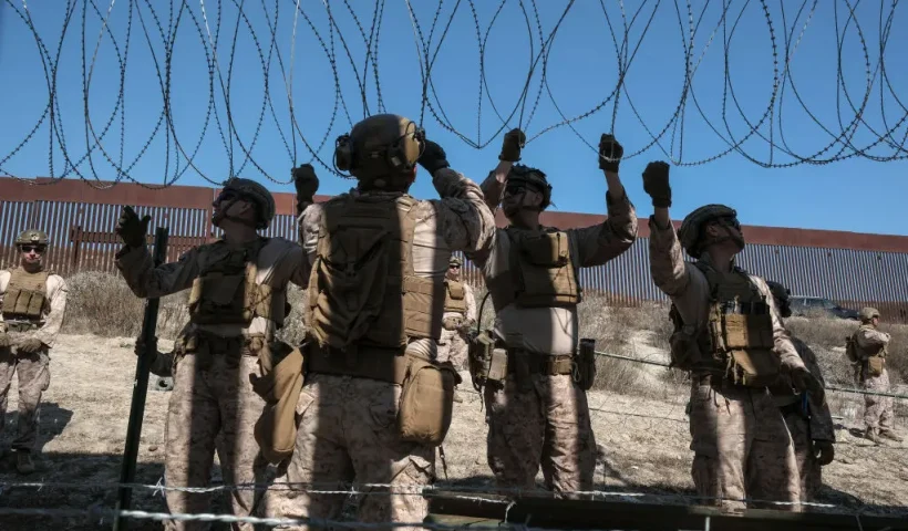 TOPSHOT - US Marine Corps deployed at the southern border in San Diego, reinforce the US-Mexico border wall as pictured from Colonia Libertad in Tijuana, Baja California state, Mexico on February 5, 2025. (Photo by Guillermo Arias / AFP) (Photo by GUILLERMO ARIAS/AFP via Getty Images)