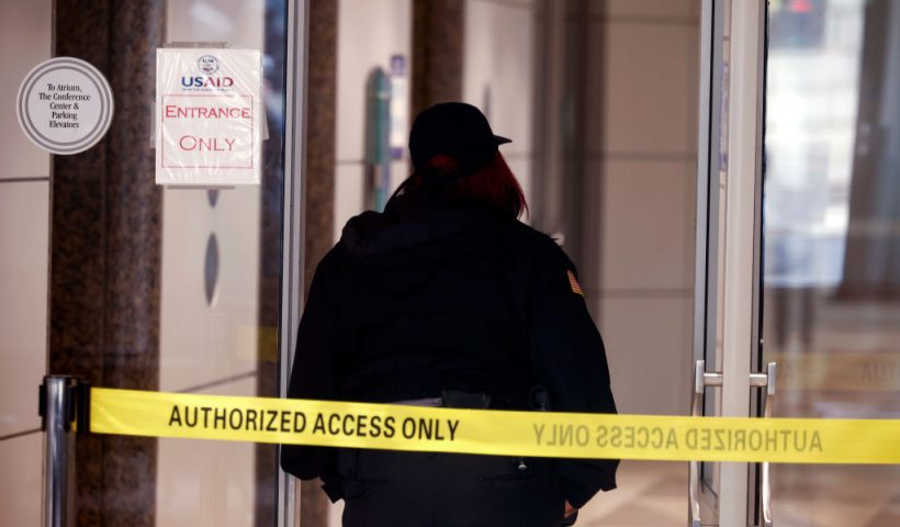 WASHINGTON, DC - FEBRUARY 03: A security guard stands at the entrance to the U.S. Agency for International Development (USAID) headquarters on February 03, 2025 in Washington, DC. Elon Musk, tech billionaire and head of the Department of Government Efficiency (DOGE), said in a social media post that he and U.S. President Doanld Trump will shut down the foreign assistance agency. (Photo by Kevin Dietsch/Getty Images)