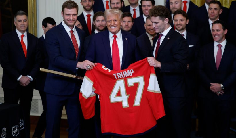 WASHINGTON, DC - FEBRUARY 03: U.S. President Donald Trump receives a jersey and a hockey stick from Florida Panthers Matthew Tkachuk (R) and Aleksander Barkov as Trump honored the Florida Panthers in the East Room of the White House on February 03, 2025 in Washington, DC. The Florida Panthers are the 2024 Stanley Cup Champions. (Photo by Kevin Dietsch/Getty Images)