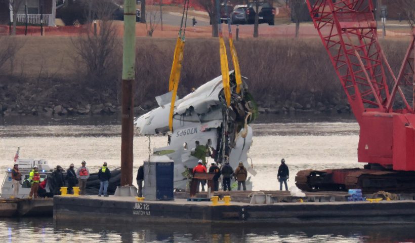A large portion of the destroyed fuselage of American Airlines flight 5342 is lifted from the Potomac River during recovery efforts on February 03, 2025 in Arlington, Virginia. An American Airlines flight from Wichita, Kansas collided midair with a military Black Hawk helicopter while on approach to Ronald Reagan Washington National Airport on January 29, 2025 outside of Washington, DC. According to reports, there were no survivors among the 67 people onboard both aircraft. (Photo by Chip Somodevilla/Getty Images)