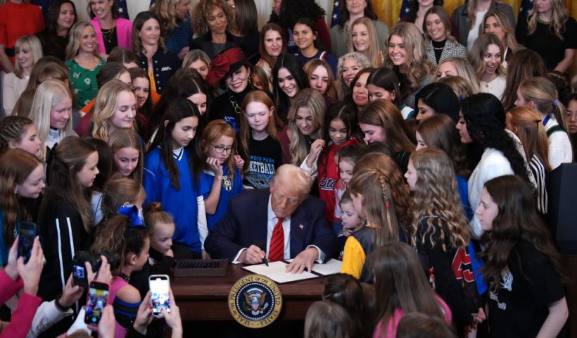 WASHINGTON, DC - FEBRUARY 05: U.S. President Donald Trump joined by women athletes signs the “No Men in Women’s Sports” executive order in the East Room at the White House on February 5, 2025 in Washington, DC. The executive order, which Trump signed on National Girls and Women in Sports Day, prohibits transgender women from competing in women’s sports and is the third order he has signed that targets transgender people. (Photo by Andrew Harnik/Getty Images)