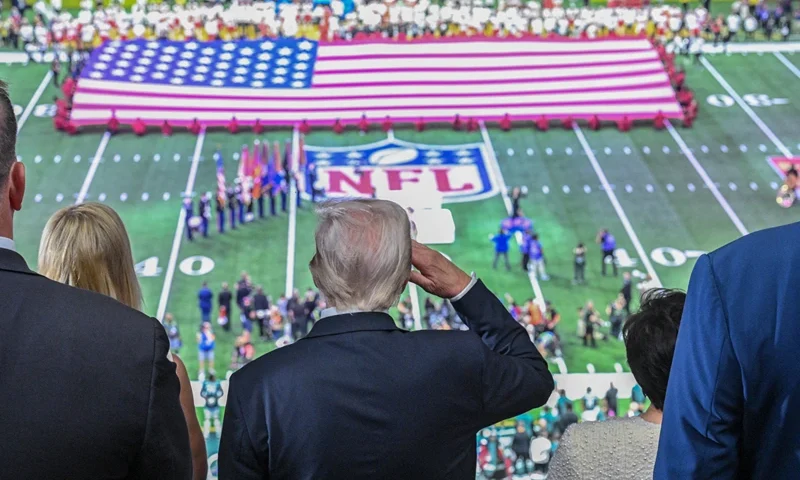 TOPSHOT - US President Donald Trump salutes as the national anthem is played before the start of Super Bowl LIX between the Kansas City Chiefs and the Philadelphia Eagles at Caesars Superdome in New Orleans, Louisiana, February 9, 2025. (Photo by ROBERTO SCHMIDT / AFP) (Photo by ROBERTO SCHMIDT/AFP via Getty Images)