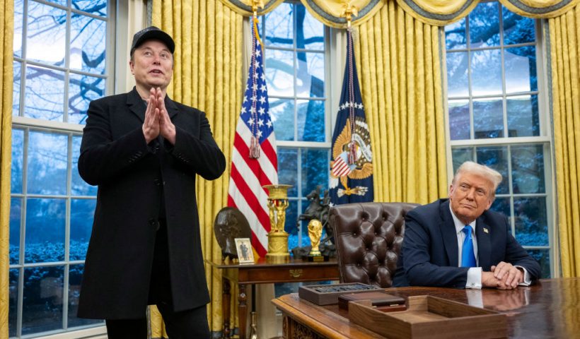 Elon Musk speaks as US President Donald Trump looks on in the Oval Office of the White House in Washington, DC, on February 11, 2025. Tech billionaire Elon Musk, who has been tapped by President Donald Trump to lead federal cost-cutting efforts, said the United States would go "bankrupt" without budget cuts. Musk leads the efforts under the newly created Department of Government Efficiency (DOGE), and was speaking at the White House with Trump, who has in recent weeks unleashed a flurry of orders aimed at slashing federal spending. (Photo by Jim WATSON / AFP) (Photo by JIM WATSON/AFP via Getty Images)