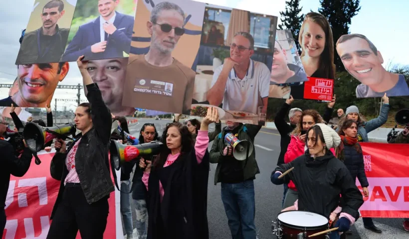 Relatives and supporters of Israeli hostages held in Gaza since the October 7, 2023 attacks, block Ayalon Highway in Tel Aviv during a protest calling for the release of all hostages, on February 13, 2025. Israel on January 12, threatened to launch a "new" war on Hamas and implement US President Donald Trump's plan to displace Palestinians from the ravaged Gaza Strip if the militants do not release hostages this weekend. (Photo by JACK GUEZ / AFP) (Photo by JACK GUEZ/AFP via Getty Images)