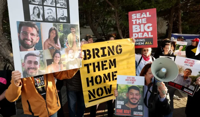 Demonstrators raise placards and chant slogans during a protest calling for the release of hostages held captive in Gaza since the October 7, 2024 attack by Palestinian militants, in front of the residence of the Israeli President in Tel Aviv on February 14, 2025. (Photo by JACK GUEZ / AFP) (Photo by JACK GUEZ/AFP via Getty Images)