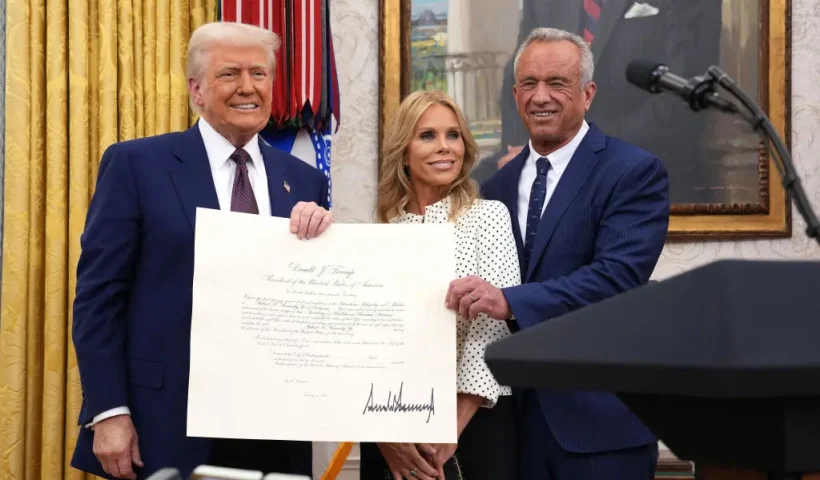 WASHINGTON, DC - FEBRUARY 13: U.S. President Donald Trump, Robert F. Kennedy Jr., and Kennedy's wife Cheryl Hines pose after Kennedy was sworn in as Secretary of Health and Human Services in the Oval Office at the White House on February 13, 2025 in Washington, DC. Kennedy, who faced criticism for his past comments on vaccine, was confirmed by the Senate 52 to 48. Former Senate Republican Leader Mitch McConnell (R-KY) was the only Republican to vote against him. (Photo by Andrew Harnik/Getty Images)