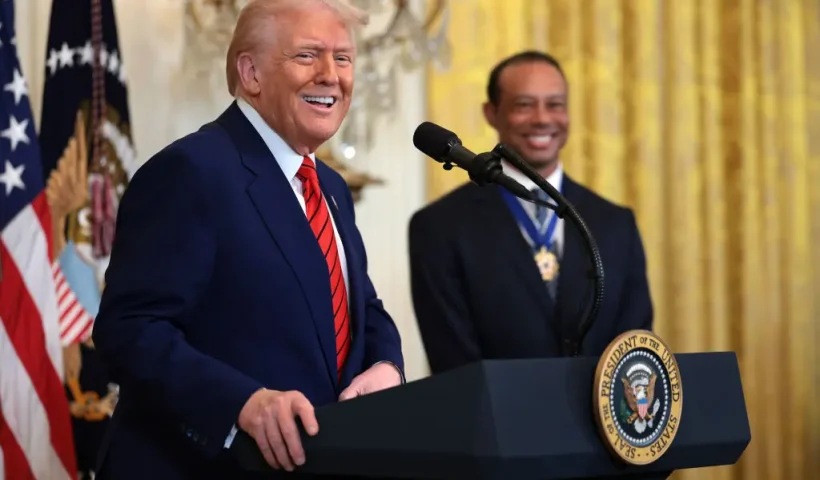 WASHINGTON, DC - FEBRUARY 20: U.S. President Donald Trump, joined by golf legend Tiger Woods, speaks during a reception honoring Black History Month in the East Room of the White House on February 20, 2025 in Washington, DC. The Black History Month celebration comes as Trump has signed a series of executive orders ending federal diversity, equity, and inclusion (DEI) programs and cutting funding to schools and Universities that do not cut DEI programs. (Photo by Win McNamee/Getty Images)