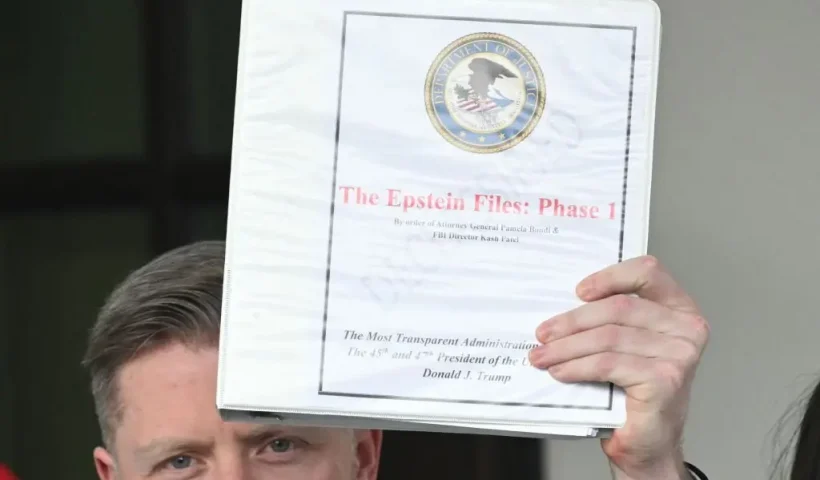 Political commentator Rogan O'Handley, aka DC Draino, and other unidentified people carrying binders bearing the seal of the US Justice Department reading "The Epstein Files: Phase 1" walk out of the West Wing of the White House in Washington, DC, on February 27, 2025. The Trump administration has said it would release documents on late tycoon and convicted sex trafficker Jeffrey Epstein who was found dead in his prison cell in 2019. (Photo by SAUL LOEB / AFP) (Photo by SAUL LOEB/AFP via Getty Images)