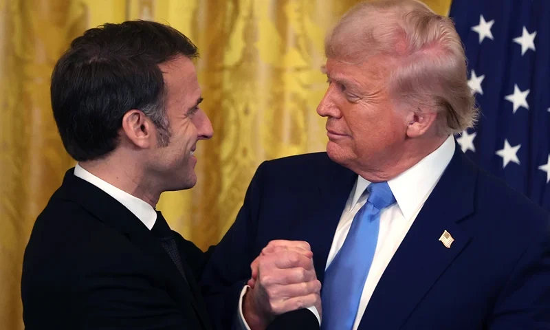U.S. President Donald Trump and French President Emmanuel Macron embrace during a joint press conference in the East Room at the White House on February 24, 2025 in Washington, DC. Macron is meeting with Trump in Washington on the third anniversary of Russia's full-scale military invasion of Ukraine. (Photo by Tasos Katopodis/Getty Images)