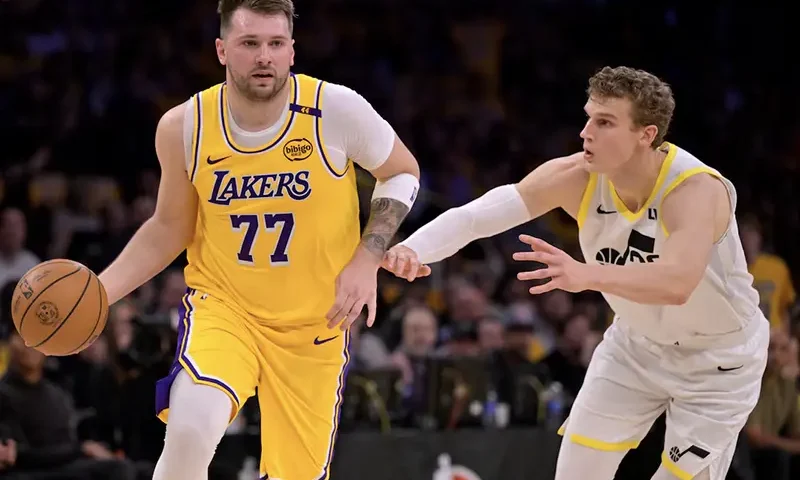 Los Angeles Lakers guard Luka Doncic (77) is defended by Utah Jazz forward Lauri Markkanen (23) in the first quarter at Crypto.com Arena. Mandatory Credit: Jayne Kamin-Oncea-Imagn Images