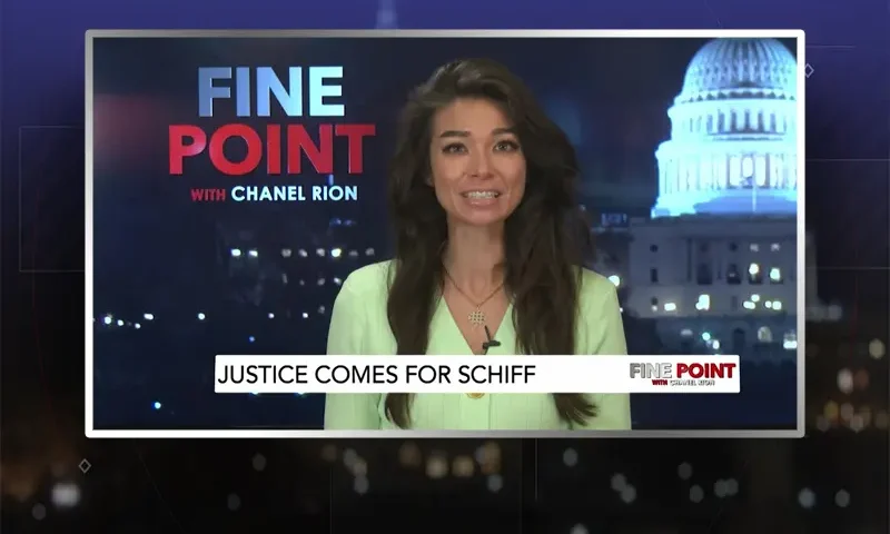 Video still of the host of Fine Point at the desk of their talk show on One America News Network.