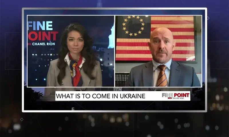 Video still from Fine Point on One America News Network showing a split screen of the host on the left side, and on the right side is the guest, Mike Sarraille.