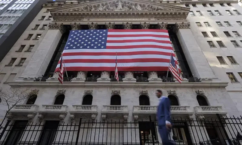 U.S. flags hang on the building of the New York Stock Exchange (NYSE), after U.S. President-elect Donald Trump won the presidential election, in New York City, U.S., November 6, 2024. REUTERS/Andrew Kelly/File photo