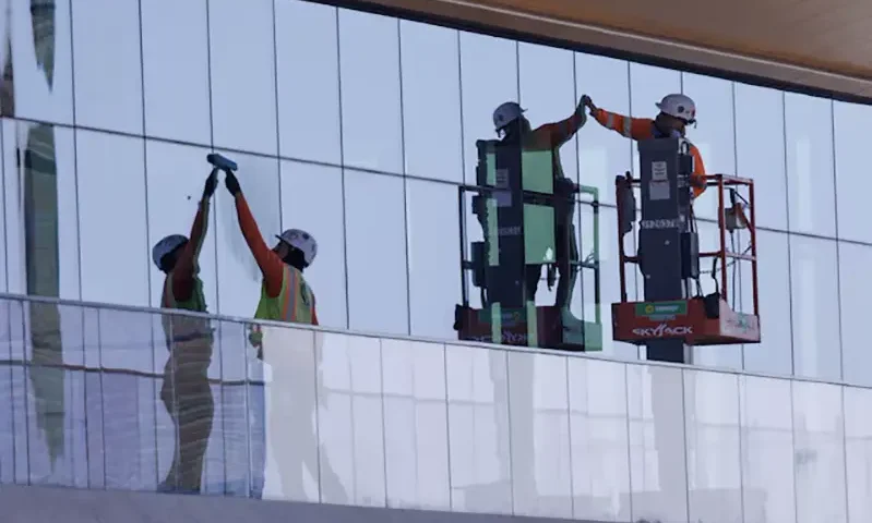 Construction workers install windows on a nearly completed office building in San Diego, California, U.S., October 9, 2024. REUTERS/Mike Blake/File Photo