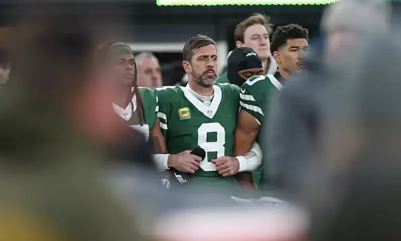 New York Jets quarterback Aaron Rodgers (8) stands with teammates during the national anthem before the game against the Miami Dolphins at MetLife Stadium. Vincent Carchietta-Imagn Images/ File Photo