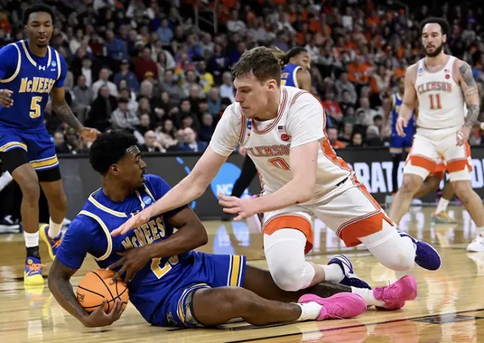 McNeese State Cowboys guard Brandon Murray (23) grabs a loose ball against Clemson Tigers center Viktor Lakhin (0) during the first half at Amica Mutual Pavilion. Mandatory Credit: Eric Canha-Imagn Images