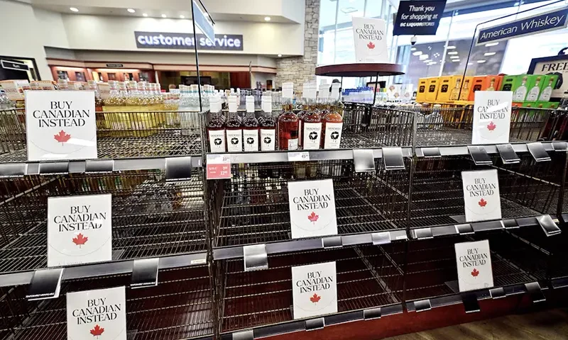 Empty shelves with Buy Canadian Instead signs are seen in the American Whiskey section of the BC Liquor in Vancouver, British Columbia, Canada March 10, 2025. REUTERS/Jennifer Gauthier//File Photo
