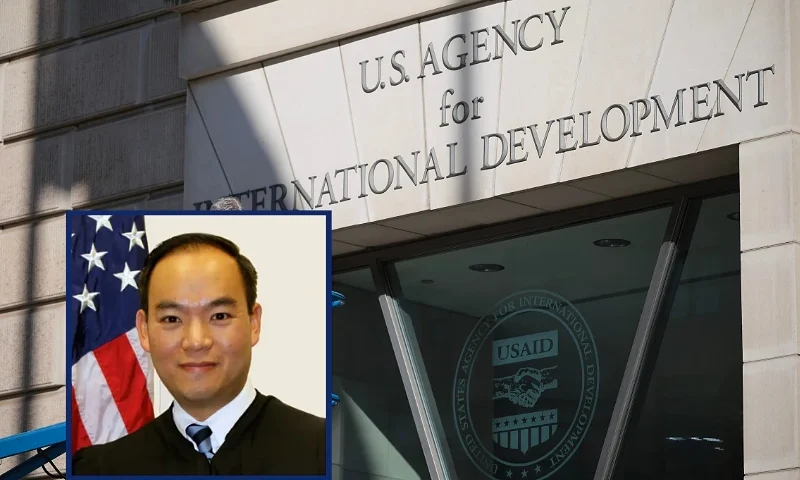 (L) U.S. District Judge Theodore Chuang. (Photo via: United States District Court - District of Maryland) / (R) WASHINGTON, DC - FEBRUARY 07: A worker removes the U.S. Agency for International Development sign on their headquarters on February 07, 2025 in Washington, DC. President Donald Trump and Elon Musk's Department of Government Efficiency (DOGE) abruptly shutdown the U.S. aid agency earlier this week leaving thousands unemployed and putting U.S. foreign diplomacy and aid programs in limbo. (Photo by Kayla Bartkowski/Getty Images)