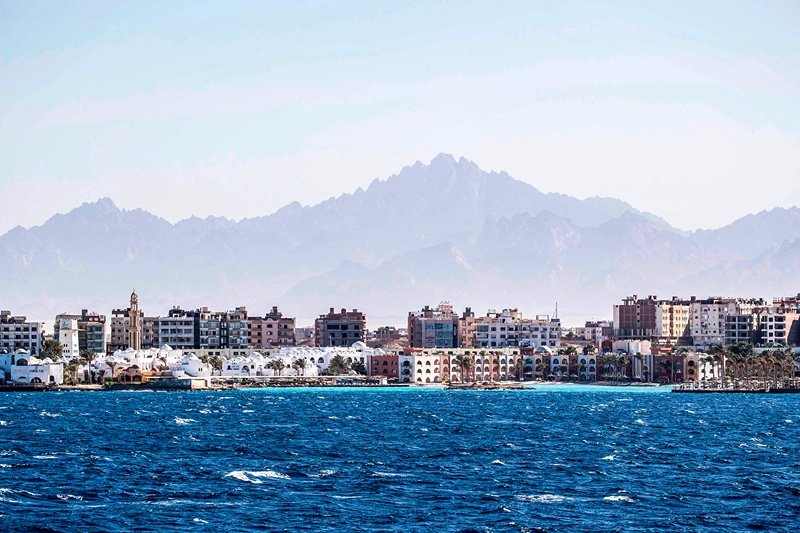 This picture taken on June 19, 2020 from a ferry shows a view of touristic resorts and bazaars in Egypt's southern Red Sea city of Hurghada, with the Red Sea hills seen in the background. (Photo by Khaled DESOUKI / AFP) (Photo by KHALED DESOUKI/AFP via Getty Images)