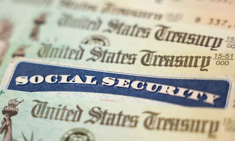WASHINGTON, DC - OCTOBER 14: In this photo illustration, a Social Security card sits alongside checks from the U.S. Treasury on October 14, 2021 in Washington, DC. The Social Security Administration announced recipients will receive an annual cost of living adjustment of 5.9%, the largest increase since 1982. The larger increase is aimed at helping to offset rising inflation. (Photo illustration by Kevin Dietsch/Getty Images)
