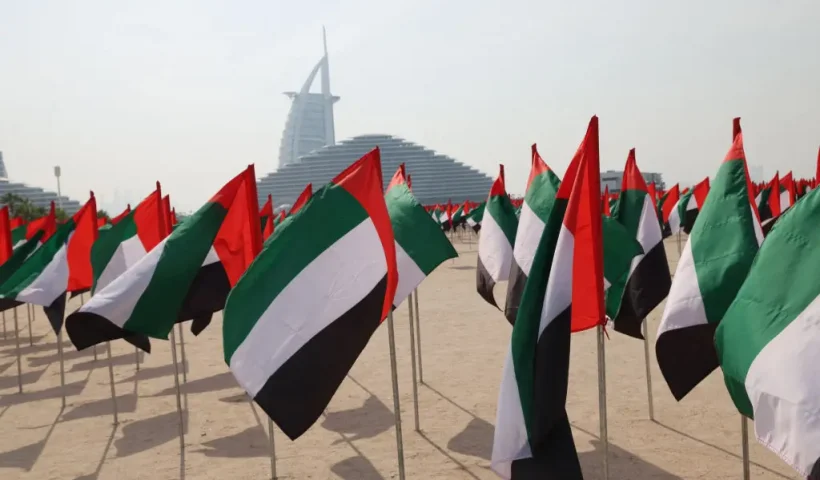 A flag garden in the colours of the United Arab Emirates is set up along the beach in front of the Burj Al-Arab building, to celebrate the annual UAE flag day in Dubai on November 3, 2023. (Photo by Giuseppe CACACE / AFP) (Photo by GIUSEPPE CACACE/AFP via Getty Images)