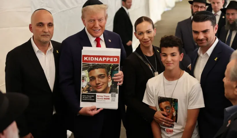 NEW YORK, NEW YORK - OCTOBER 07: Republican presidential nominee, former U.S. President Donald Trump, poses for photos with the family of Edan Alexander at Ohel Chabad Lubavitch on October 07, 2024 in New York City. Trump commemorated the one-year anniversary of October 7th by visiting to Ohel Chabad Lubavitch, the final resting place of Rabbi Menachem M. Schneerson the Rebbe, with the family of Edan Alexander, who was taken hostage by Hamas on October 7th, in attendance. On October 7, the Palestinian militant group Hamas launched a surprise attack on Israel from Gaza by land, sea, and air, killing more than 1,200 people and taking Israeli soldiers and civilians hostage. To date, there are over 90 people still being held hostage by Hamas. (Photo by Michael M. Santiago/Getty Images)