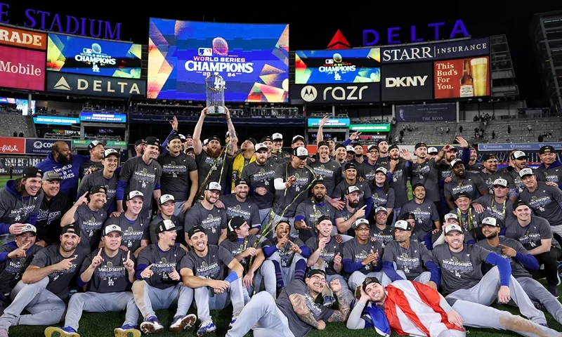 VThe Los Angeles Dodgers pose on the field after defeating the New York Yankees 7-6 in game 5 to win the 2024 World Series at Yankee Stadium on October 30, 2024 in the Bronx borough of New York City. (Photo by Elsa/Getty Images)