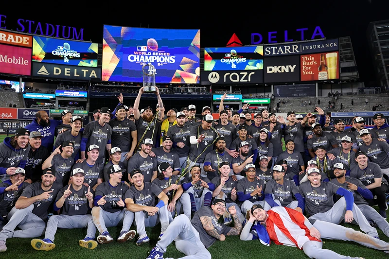 VThe Los Angeles Dodgers pose on the field after defeating the New York Yankees 7-6 in game 5 to win the 2024 World Series at Yankee Stadium on October 30, 2024 in the Bronx borough of New York City. (Photo by Elsa/Getty Images)