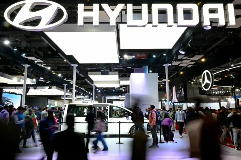 People walk past a Hyundai exhibition booth at the Bharat Mobility Global Expo 2025, in New Delhi on January 21, 2025. (Photo by Money SHARMA / AFP) (Photo by MONEY SHARMA/AFP via Getty Images)
