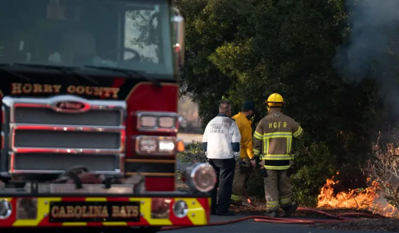MYRTLE BEACH, SOUTH CAROLINA - MARCH 02: Firefighters attend to a flare-up in the Carolina Forest neighborhood on March 2, 2025 in Myrtle Beach, South Carolina. Multiple forest fires in the area have caused evacuations along the South Carolina coast. (Photo by Sean Rayford/Getty Images)