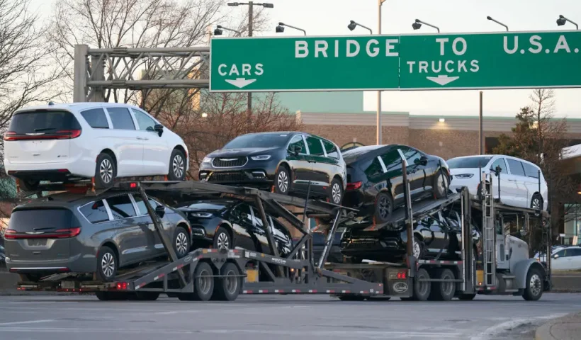 A truck carrying vehicles prepares to cross into the US from Canada at the Ambassador Bridge in Windsor, Ontario, on March 8, 2025. US President Donald Trump imposed vast tariffs this week on key partners Canada and Mexico, roiling cross-border ties before offering temporary relief to manufacturers -- but with more levies kicking in next week, the respite may be fleeting. (Photo by Geoff Robins / AFP) (Photo by GEOFF ROBINS/AFP via Getty Images)