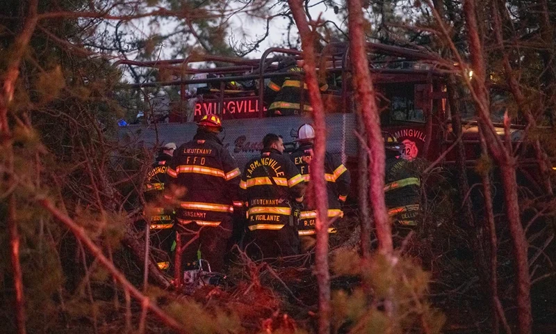Firefigters assemble around rescue units while putting out fires on March 8, 2025 in Westhampton, New York. As strong winds fueled multiple brush fires on New York's Long Island, closing roads and reportedly burning structures. (Photo by Andrew Theodorakis/Getty Images)