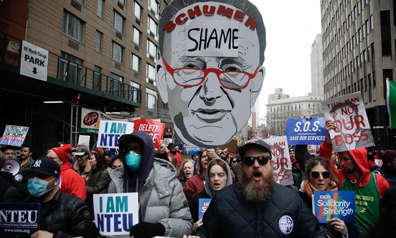 Demonstrators take part in a "March to Stop the Cuts" protest in New York on March 15, 2025. A controversial Republican spending bill passed the US Senate on March 14 with support of Minority Leader Chuck Schumer of New York and other Democratic senators. The measure slashes billions of dollars from public spending at a time government agencies are already reeling from the dismissal of thousands of civil servants by Trump and his chief waste hunter, Elon Musk. (Photo by Leonardo Munoz / AFP) (Photo by LEONARDO MUNOZ/AFP via Getty Images)