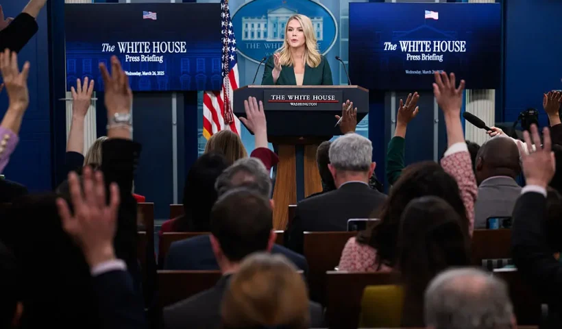 Reporters raise their hand to ask a question as White House Press Secretary Karoline Leavitt speaks during the daily briefing in the Brady Briefing Room of the White House in Washington, DC, on March 26, 2025. (Photo by MANDEL NGAN / AFP) (Photo by MANDEL NGAN/AFP via Getty Images)