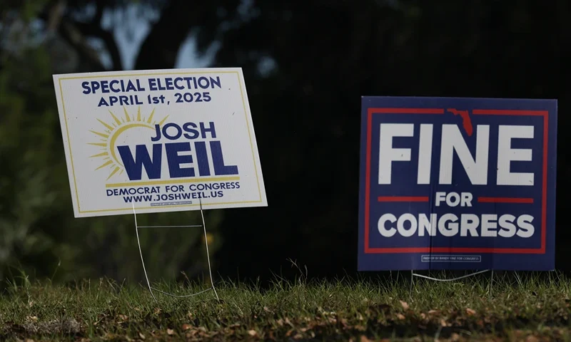 OCALA, FLORIDA - MARCH 26: Campaign signs sit on the side of the road supporting Democratic nominee Josh Weil outside of his campaign event at the Silver Springs Shores Community Center on March 26, 2025 in Ocala, Florida. Polls show that Mr. Weil is within the margin of error in defeating Republican Randy Fine to flip National Security Advisor Mike Waltz's old seat in the U.S. House of Representatives. The race for the 6th district is one of two Florida Congressional special elections set for April 1st. (Photo by Joe Raedle/Getty Images)